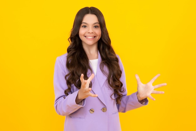 Teenager child pointing to the side with a finger to present a product or idea Teen girl in casual outfit pointing empty space Happy teenager positive and smiling emotions of teen girl