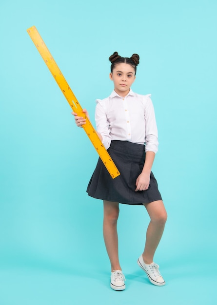 Teenager child school girl holding measure for geometry lesson Measuring height Measuring equipment Kid student study math Knowledge day