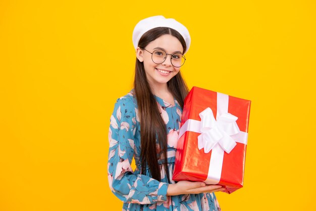 Teenager child with gift box present for holidays happy birthday valentines day new year or christmas kid hold present box happy teenager positive and smiling emotions