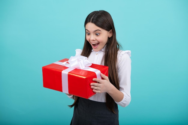 Teenager child with gift box Present for holidays Happy birthday Valentines day New Year or Christmas Kid hold present box Surprised emotions of young girl