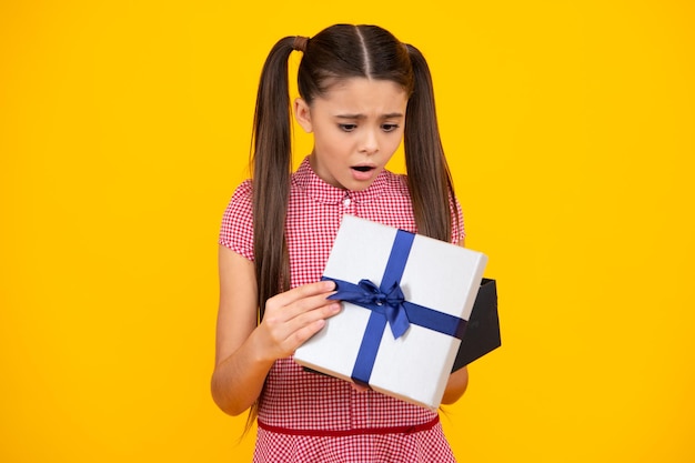 Teenager child with gift box present for holidays happy birthday valentines day new year or christmas kid hold present box unhappy sad teenager girl