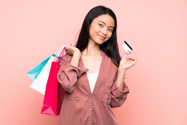 Teenager Chinese girl isolated on pink