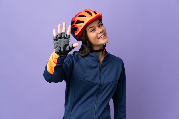 Teenager cyclist girl counting five with fingers