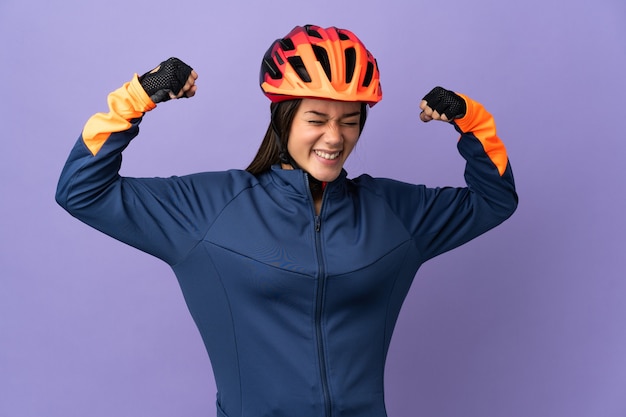 Teenager cyclist girl doing strong gesture