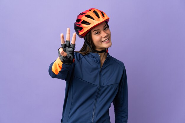 Teenager cyclist girl happy and counting three with fingers