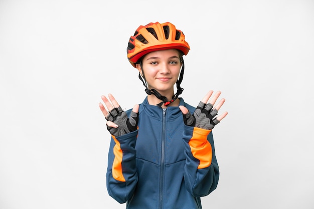 Teenager cyclist girl over isolated white background counting nine with fingers