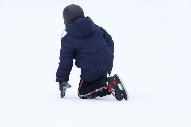 The teenager fell skating on the ice rink