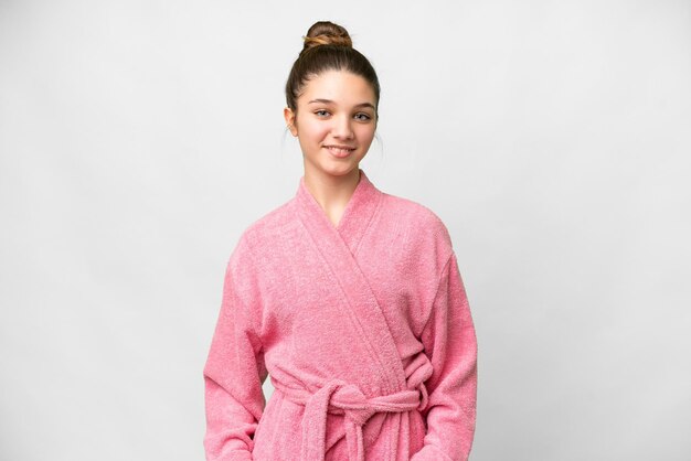 Photo teenager girl in a bathrobe over isolated white background laughing