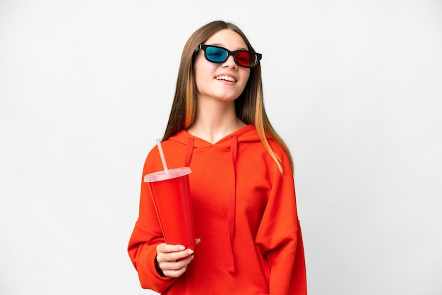 Teenager girl in a cinema over isolated white background laughing