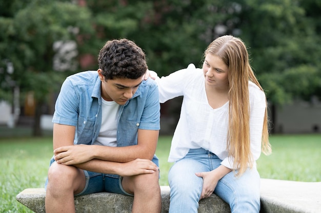 Teenager girl comforting sad boyfriend