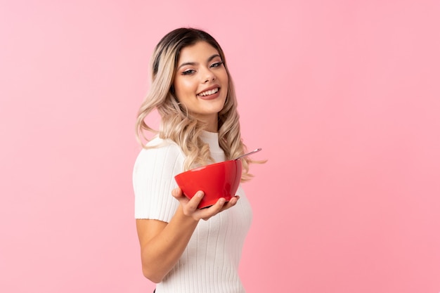 Teenager girl holding a bowl of cereals