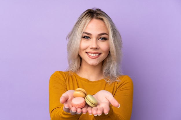 Teenager girl holding macaroons