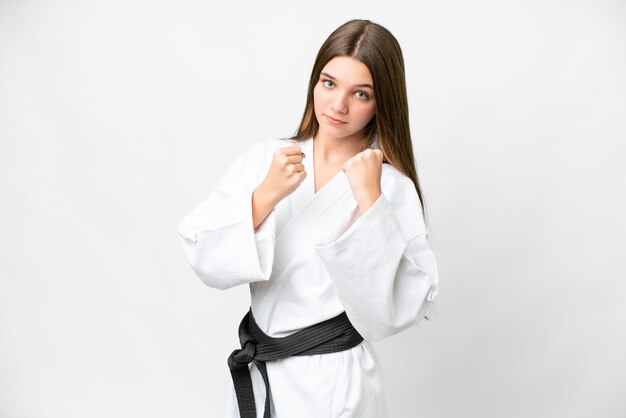 Teenager girl over isolated white background doing karate