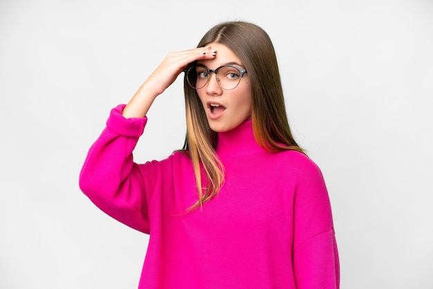 Photo teenager girl over isolated white background doing surprise gesture while looking front