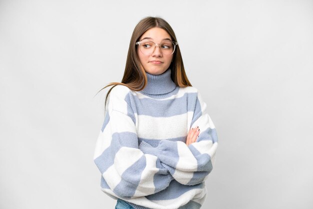 Teenager girl over isolated white background making doubts gesture while lifting the shoulders