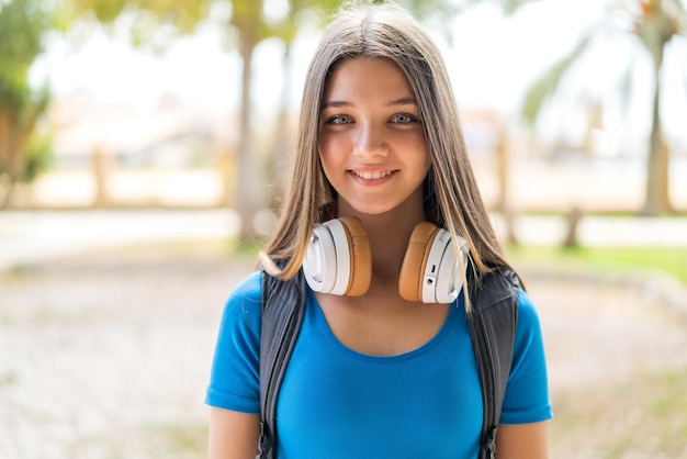 Teenager girl at outdoors with happy expression