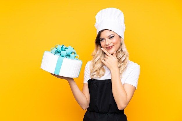 Teenager girl pastry holding a big cake