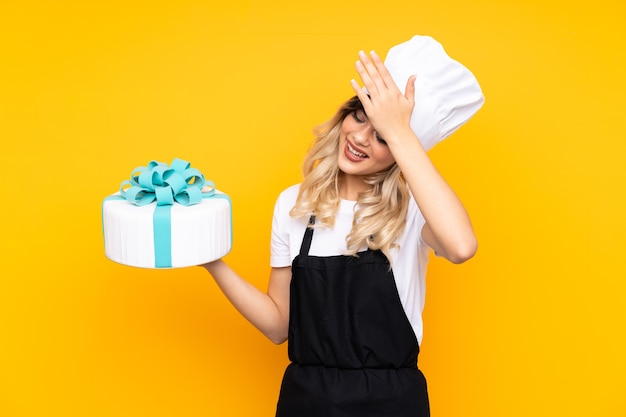 Teenager girl pastry holding a big cake