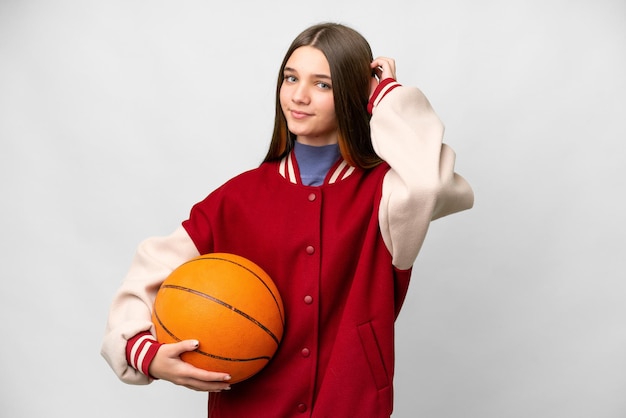 Teenager girl playing basketball over isolated white background having doubts