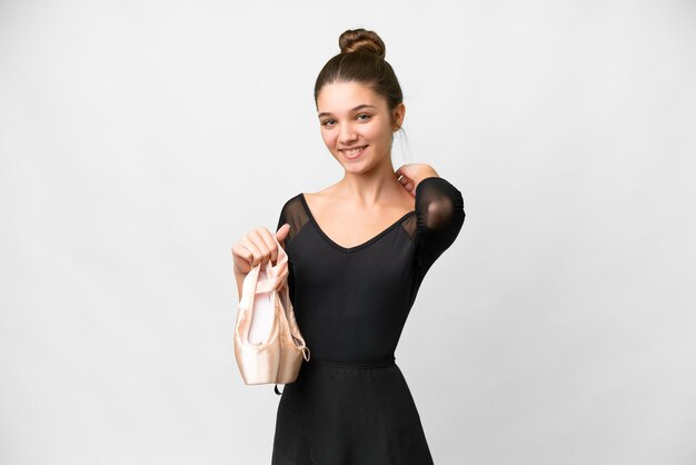 Teenager girl practicing ballet over isolated white background laughing