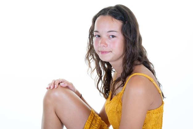 Teenager girl pretty beauty slim brunette teen sit on white wall background
