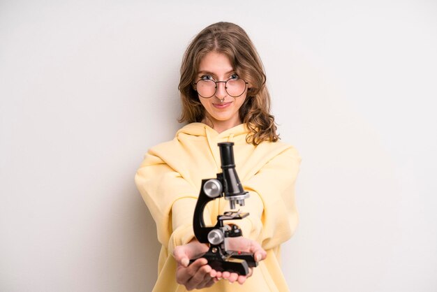 Teenager girl scientist student with a microscope