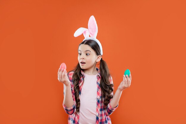 Teenager girl wear rabbit costume. easter bunny egg hunt. just having fun. ready for party. happy childhood. amazed bunny kid. happy easter holiday. funny child with painted eggs.