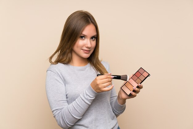 Teenager girl with makeup palette 