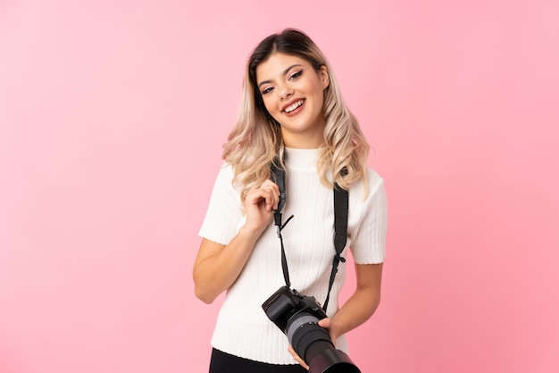 Teenager girl with a professional camera and with thumb up