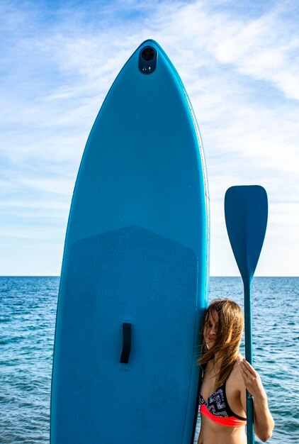 Teenager girl with puddle board sup