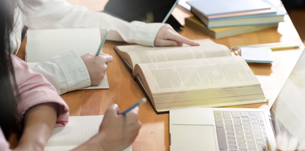 Teenager girls doing group study  