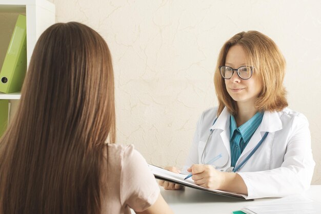 teenager healthcarepatient at a doctor's appointment in a medical office receives a consultation passes tests prescribes pills