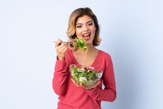 Teenager holding salad isolated