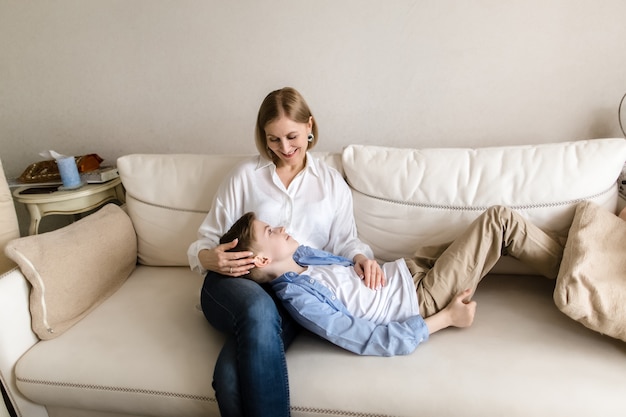 Teenager lies on the lap of an adult woman