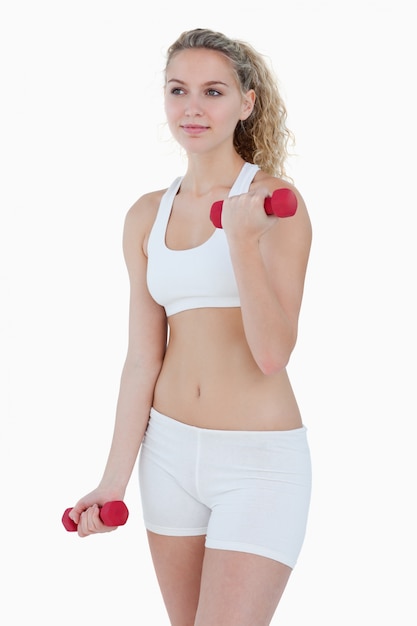 Teenager looking to the side while lifting weights