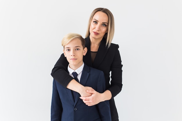 Teenager and mother wearing suits