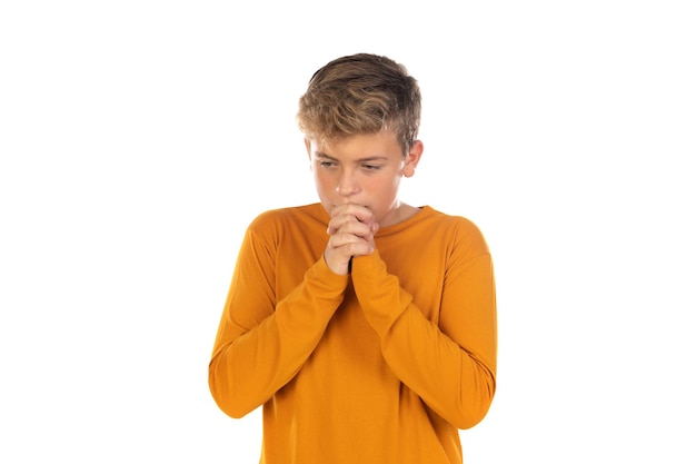 Teenager in orange tshirt praying