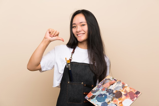 Teenager painter asian girl proud and self-satisfied