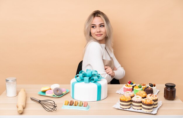 Teenager pastry chef with a big cake