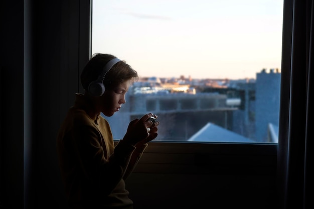 Teenager playing near the window