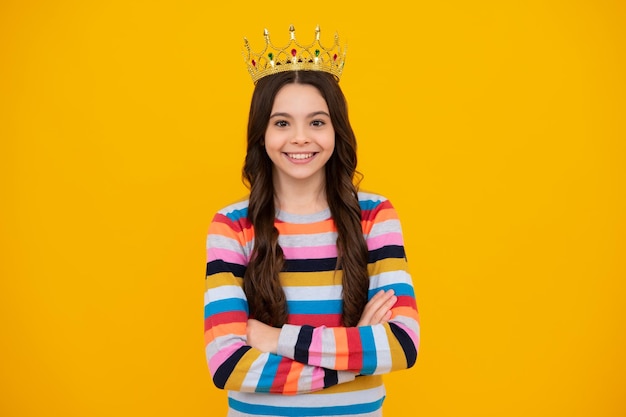 Teenager princess child celebrates success win and victory teen\
girl in queen crown happy teenager positive and smiling emotions of\
teen girl