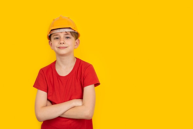 Teenager in protective helmet on yellow wall