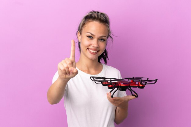 Premium Photo | Teenager russian girl holding a drone isolated on ...