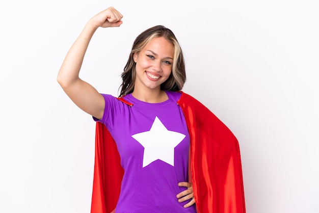 Teenager Russian girl isolated on white background in superhero costume and doing strong gesture