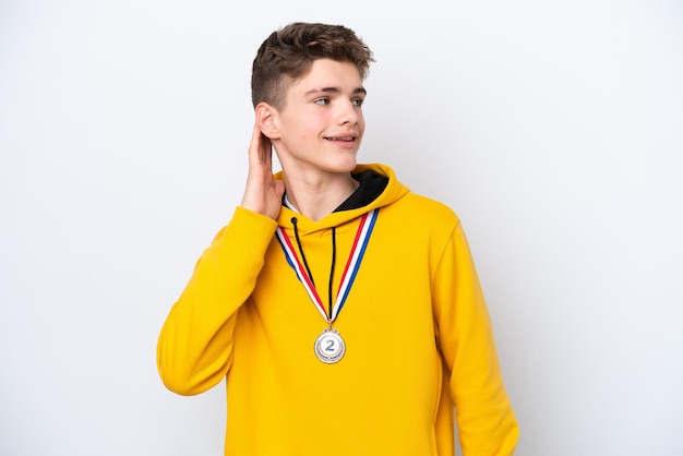 Teenager Russian man with medals isolated on white background thinking an idea