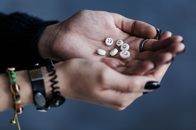 Teenager's hands with colorful pills