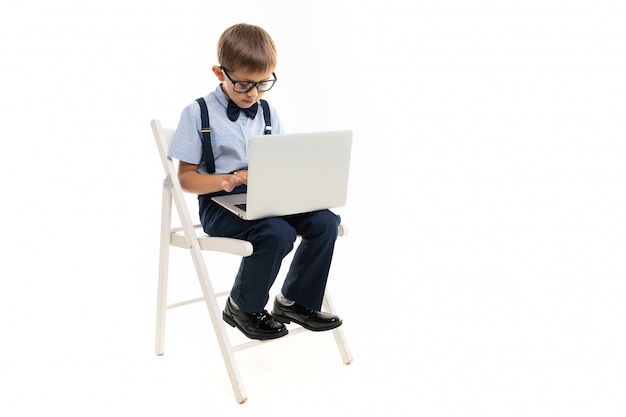 Teenager school boy do homework with laptop, isolated