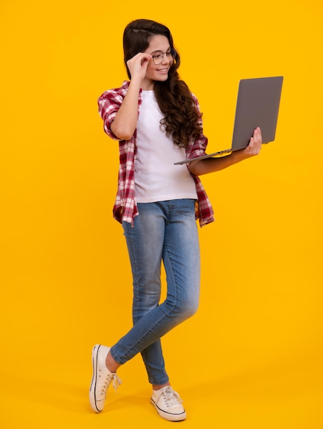 Teenager school girl hold notebook laptop School children on isolated studio background Happy