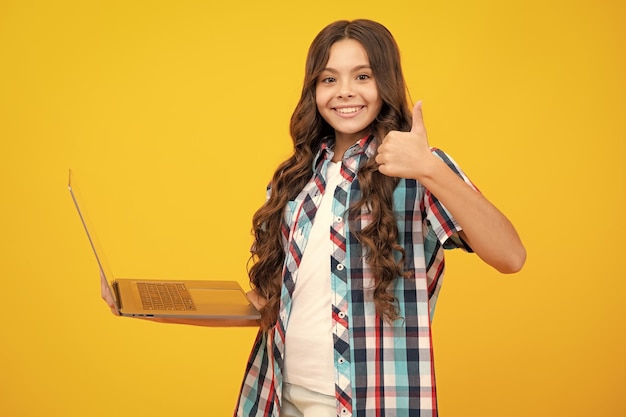 Teenager school girl hold notebook laptop School children on isolated studio background