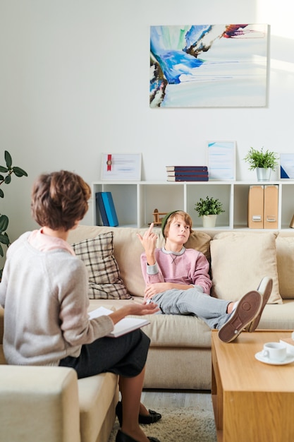 Photo teenager showing middle finger to his psychiatrist